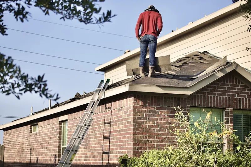 Professional roofer working on a residential roof in Edgewood Garden